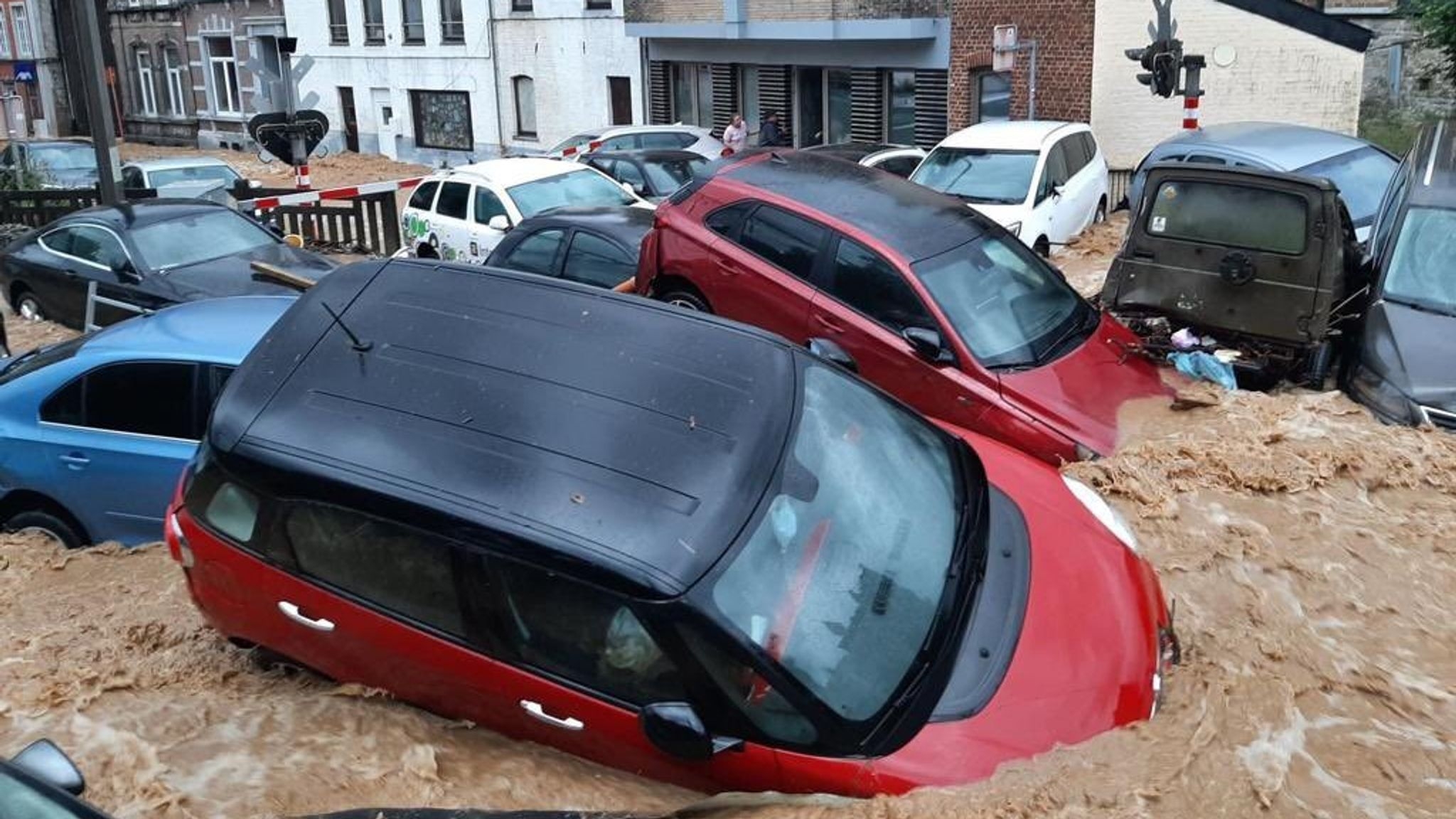 Heavy rainfall washed away cars, leaving them strewn across the town. 